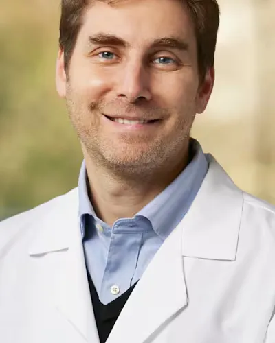 Portrait of Raphael E. Szalat in a white coat